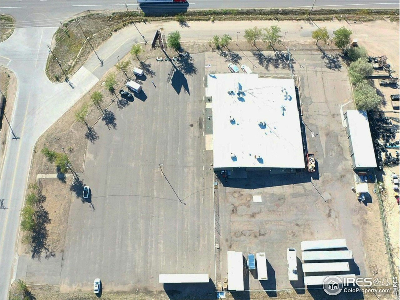 Top-down aerial view of the building and paved site